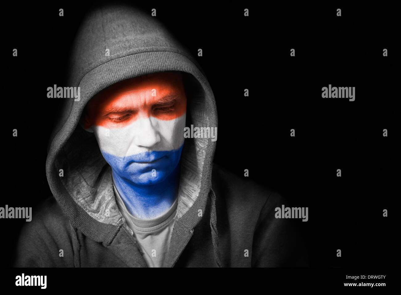 A sad expression on the face of a football fan with their face painted