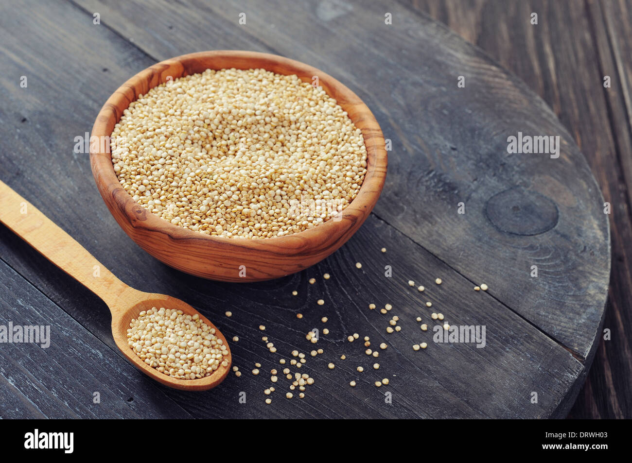 Raw quinoa seeds in the wooden bowl on wooden background closeup Stock Photo
