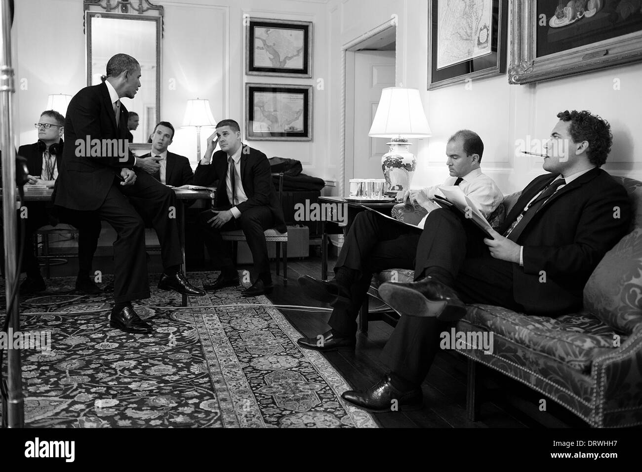 US President Barack Obama works on his address to the nation on Syria with staff in the Map Room of the White House September 10, 2013 in Washington, DC. Seated from right are: Director of Speechwriting Cody Keenan; Ben Rhodes, Deputy National Security Advisor for Strategic Communications; Senior Advisor Dan Pfeiffer; and former Director of Speechwriting Jon Favreau. Stock Photo