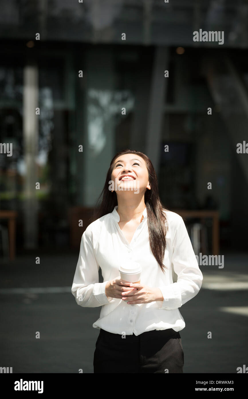 Chinese business woman looking upwards. Concept: businesswoman looking up and dreaming Stock Photo