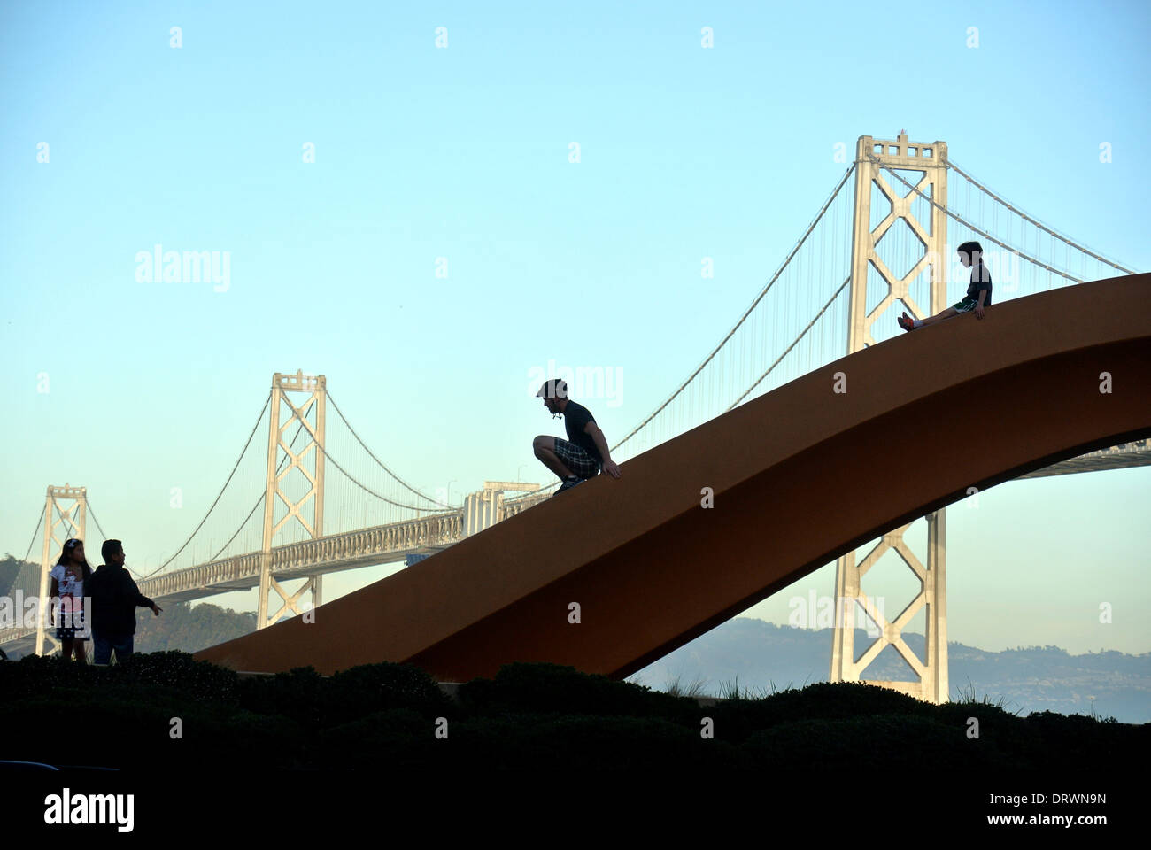 family plays on sculpture on embarcadera in San Francisco Stock Photo
