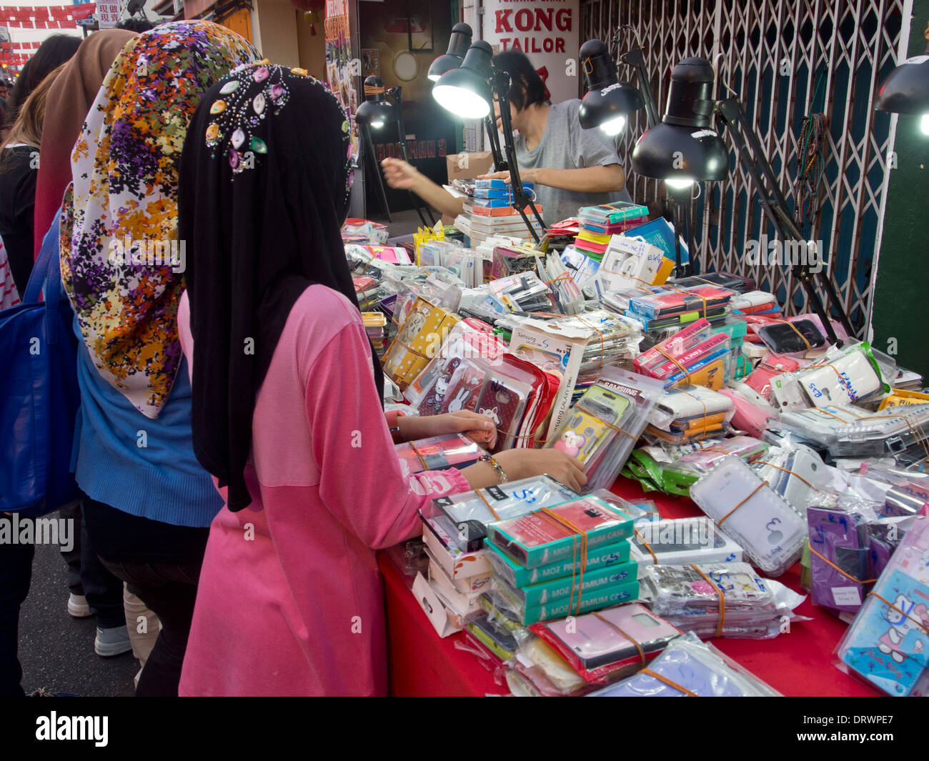 Muslim women at phone accessories street stall in Malacca, a UNESCO World  Heritage Site, Malaysia Stock Photo - Alamy