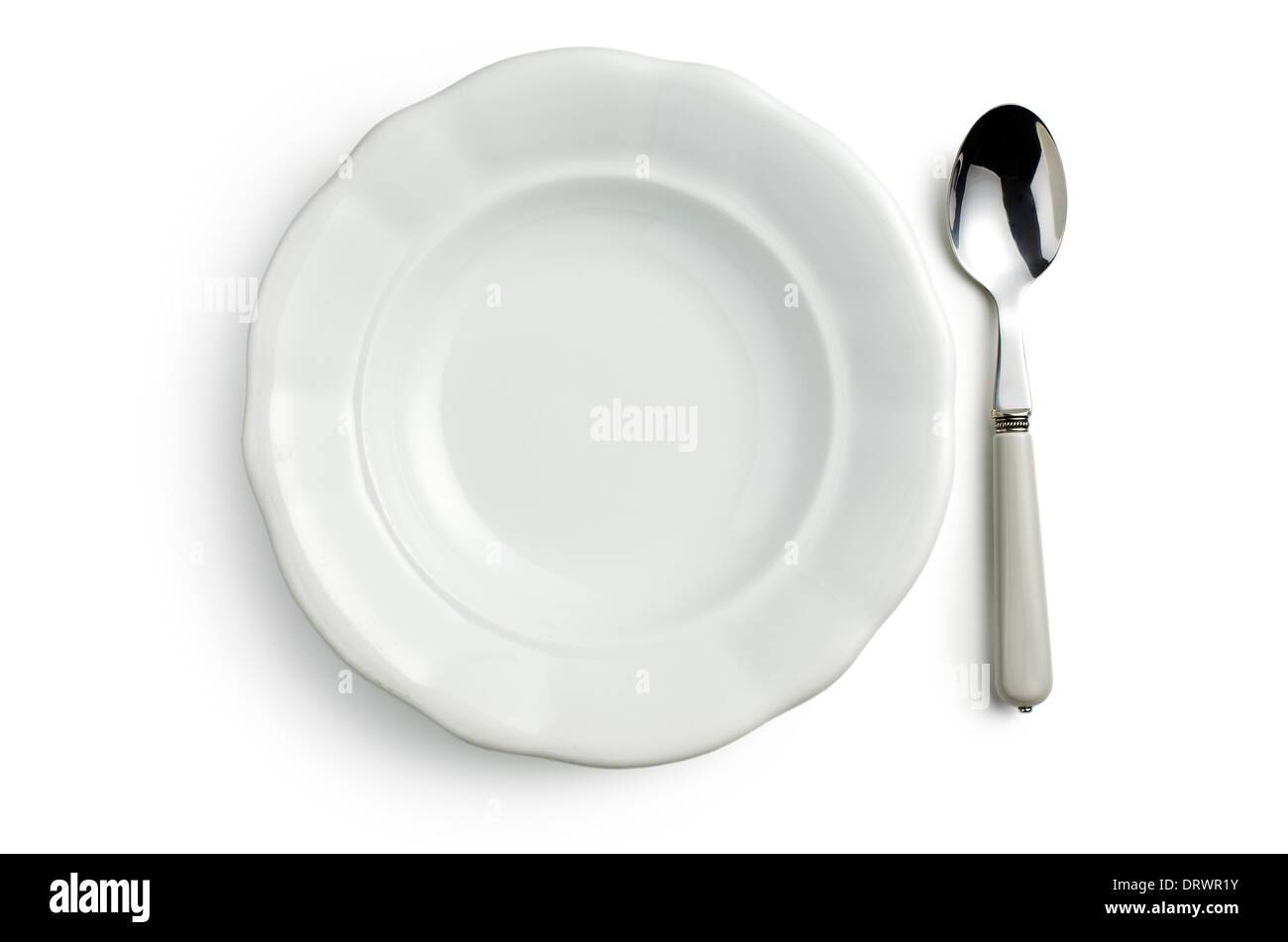 top view of white ceramic plate with spoon on white background Stock Photo
