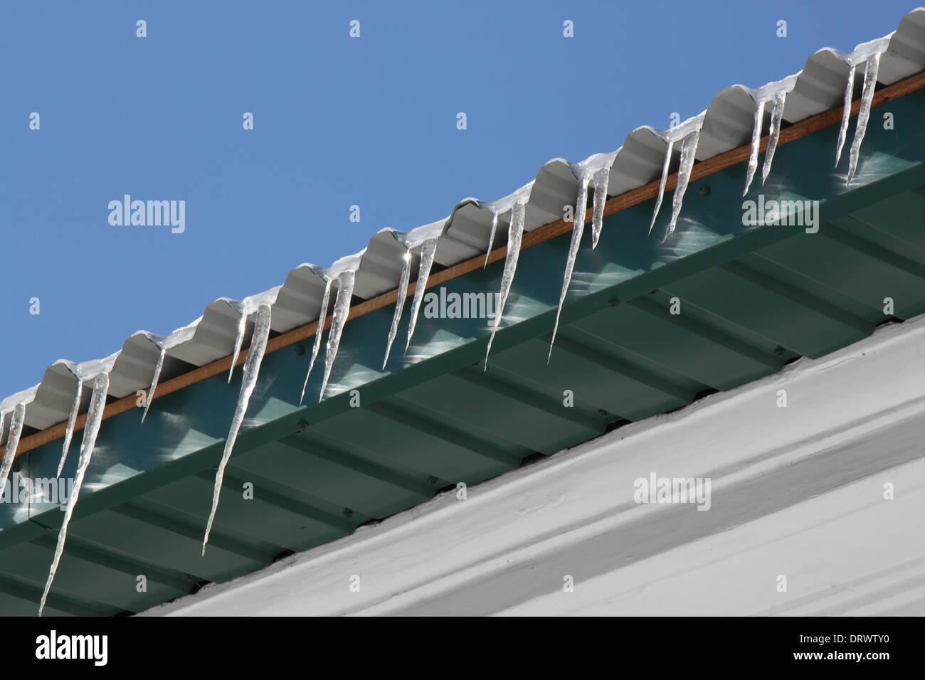icicles on roof of building Stock Photo