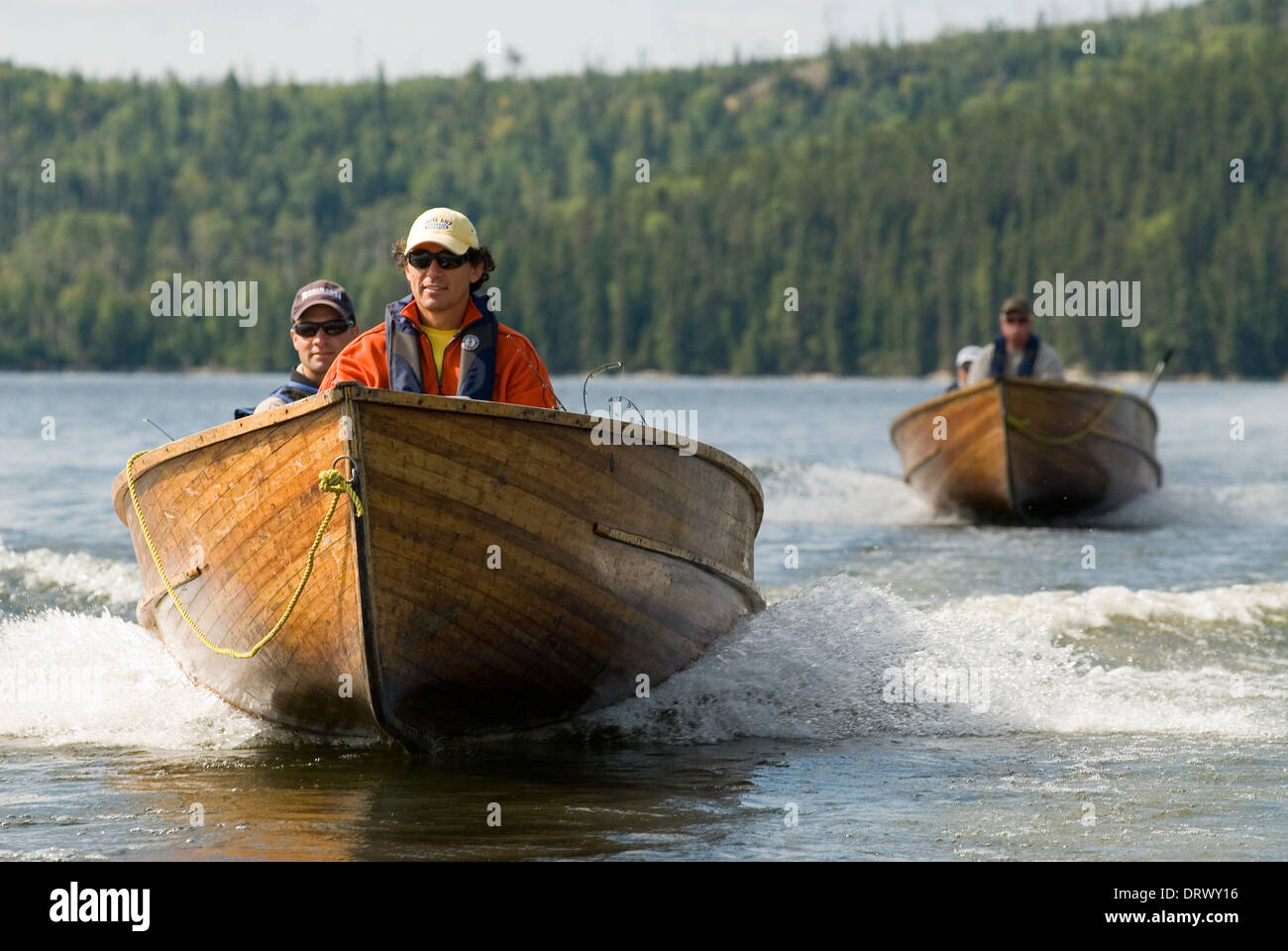 Fishermen traveling in wooden motor boats on a Northern Ontario lake. Stock Photo
