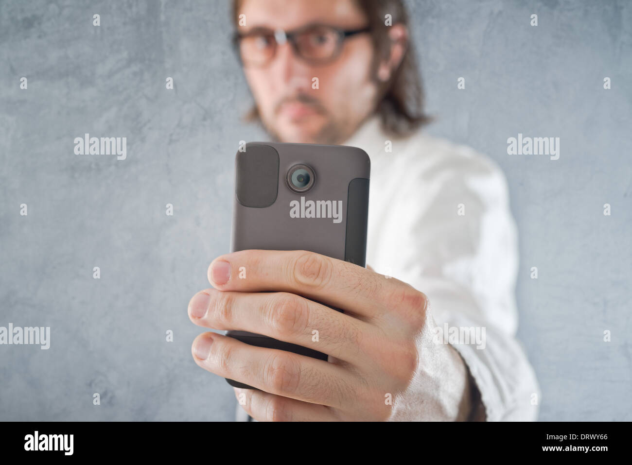 Businessman taking picture with mobile phone, selective focus on device and hand Stock Photo