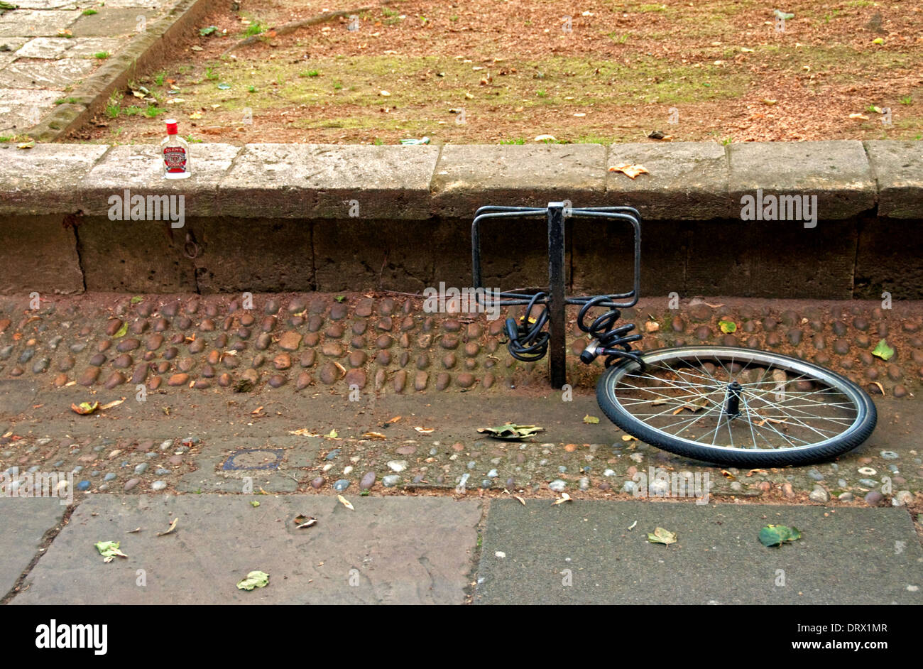 Bicycle wheel locked to post Stock Photo Alamy