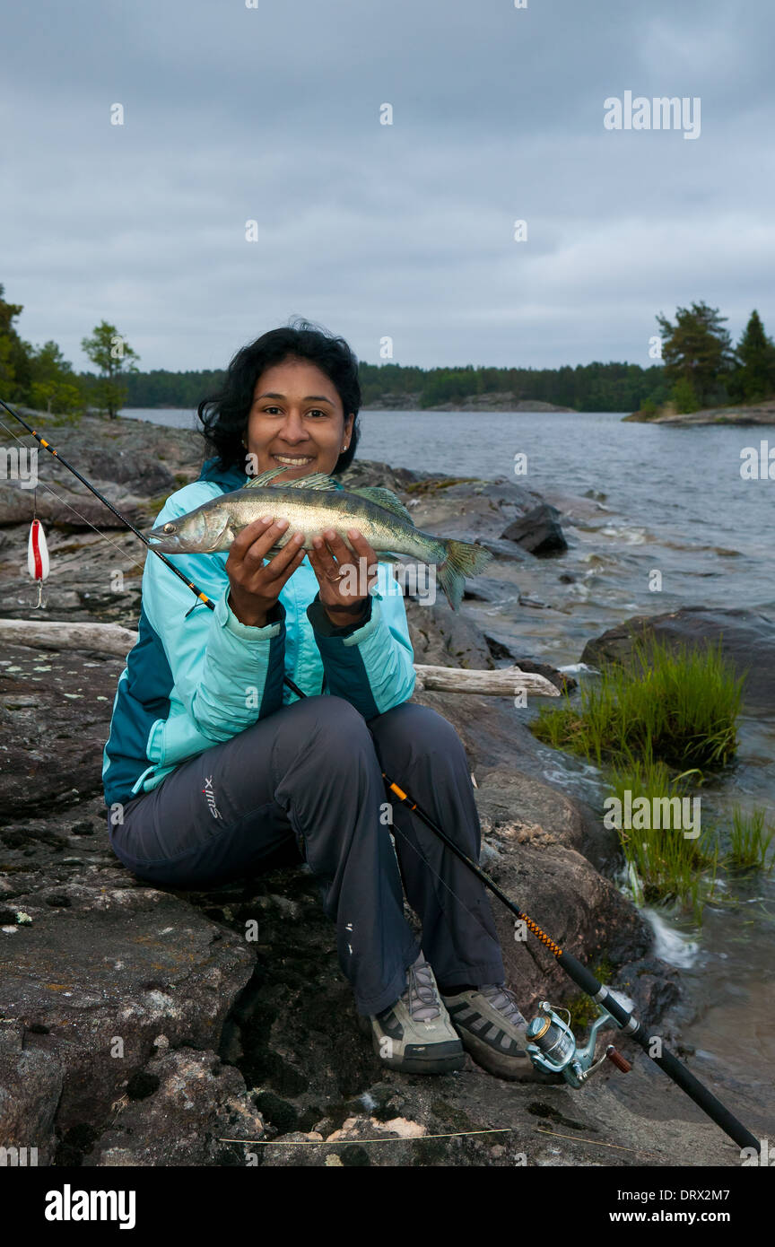 Girl with a Zander, Sander lucioperca,  caught in the lake Vansjø, Østfold, Norway. Vansjø is a part of the water system called Morsavassdraget. Stock Photo