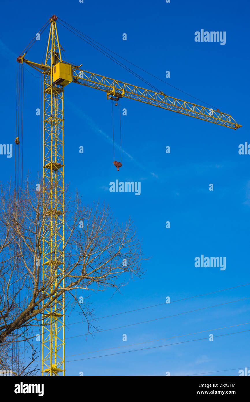 Tower crane against blue sky background Stock Photo