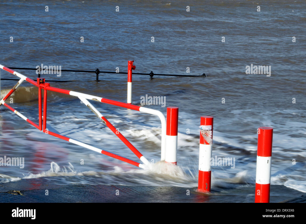 Waves breaking on slip road leading down to beach on Hoylake Promenade in the Wirral North West England Stock Photo