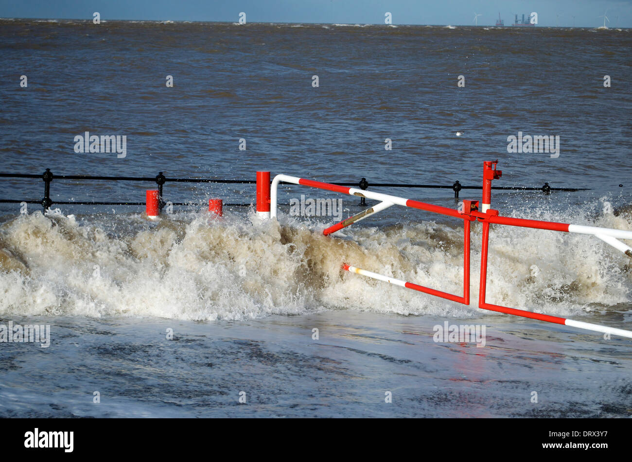 Waves breaking on slip road leading down to beach on Hoylake Promenade in the Wirral North West England Stock Photo