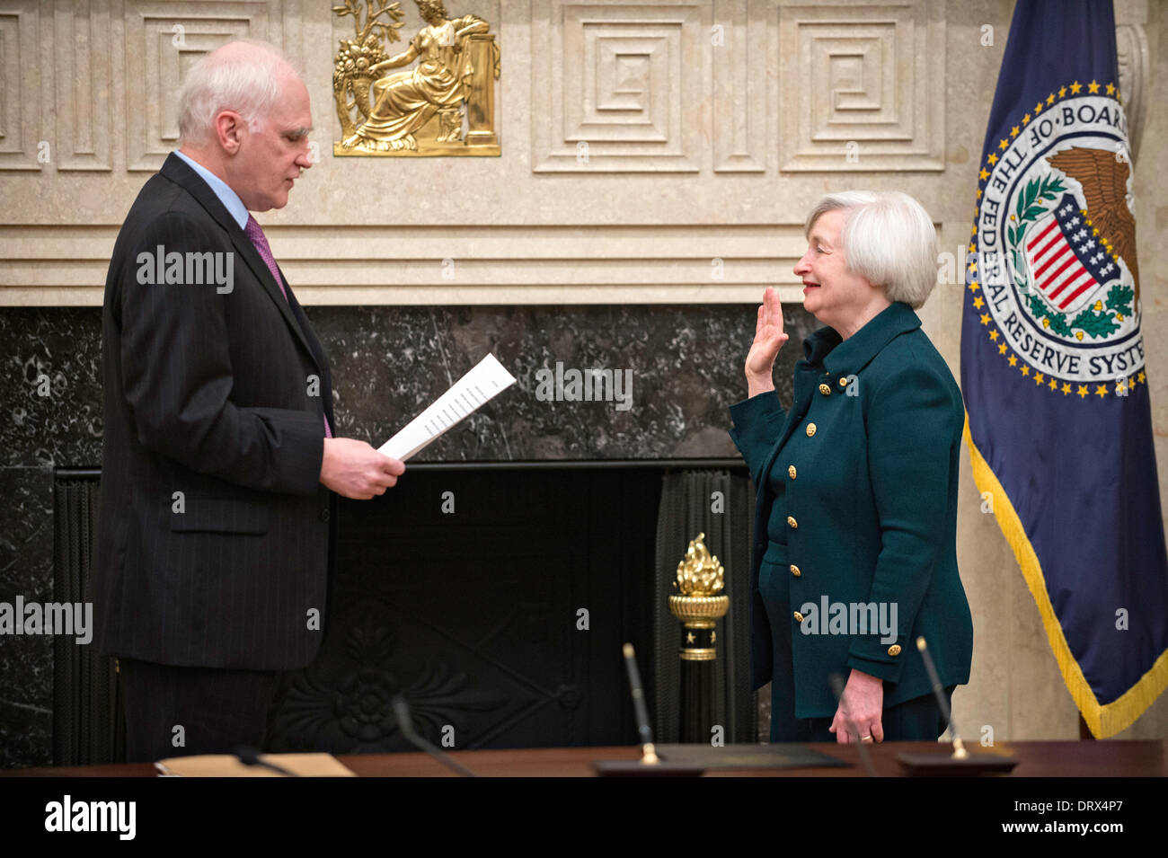 Janet Yellen takes the oath of office to become Chair of the Board of Governors of the Federal Reserve System at the Marriner S. Eccles Federal Reserve Board Building from Governor Daniel K. Tarullo February 3, 2014 in Washington, DC. Yellen replaces Ben Bernanke and is the first woman to hold the post. Stock Photo