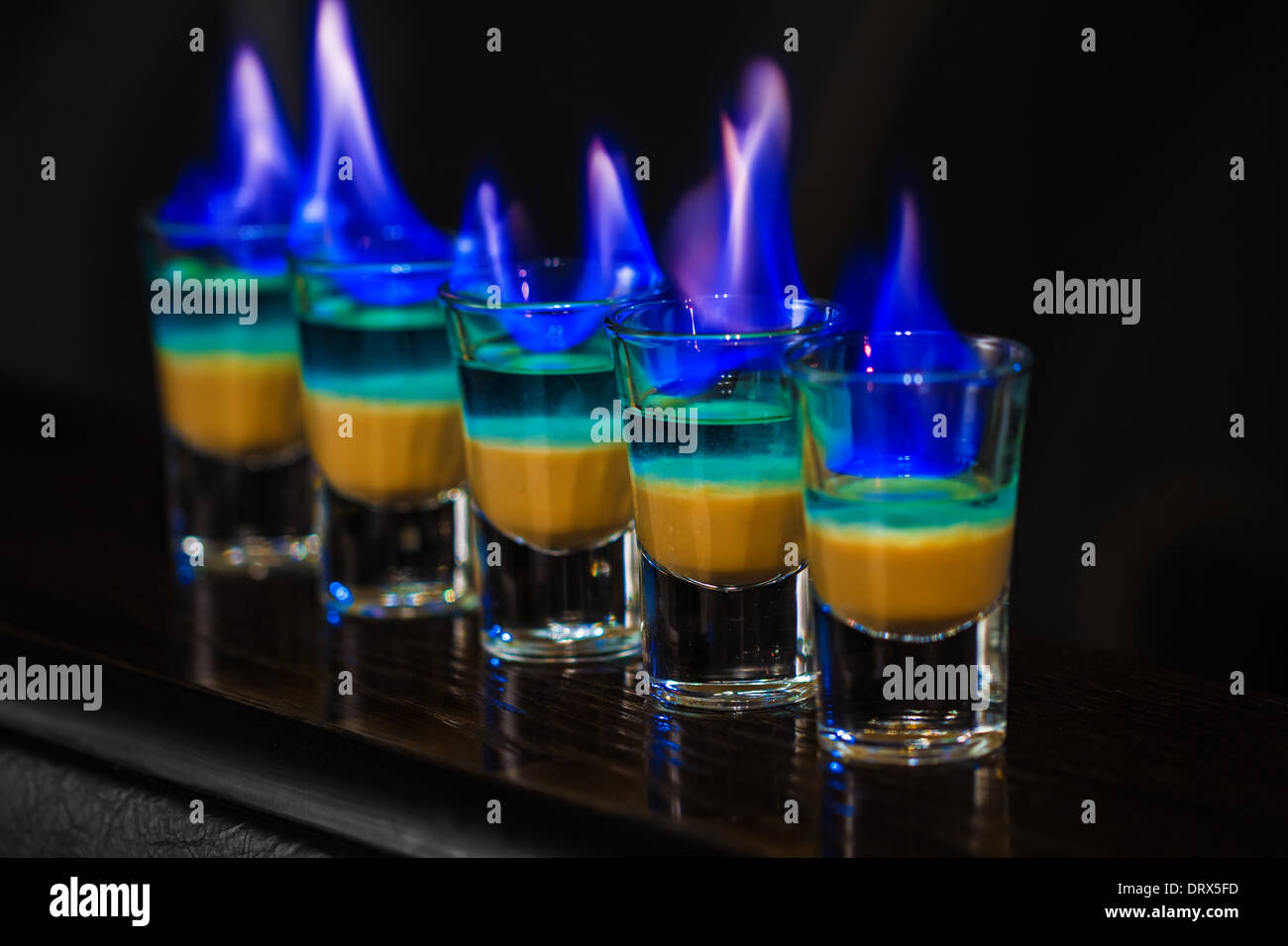 Barman make alcoholic shots in nightclub Stock Photo