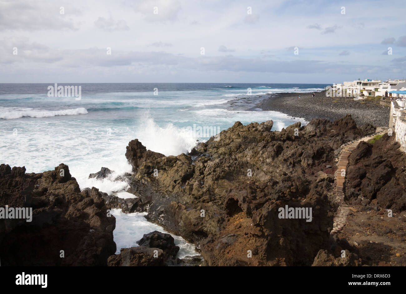 El Golfo Lanzarote Atlantic Ocean rollers pound volcanic lava rocky cliffs at this small village with waterfront restaurants Stock Photo