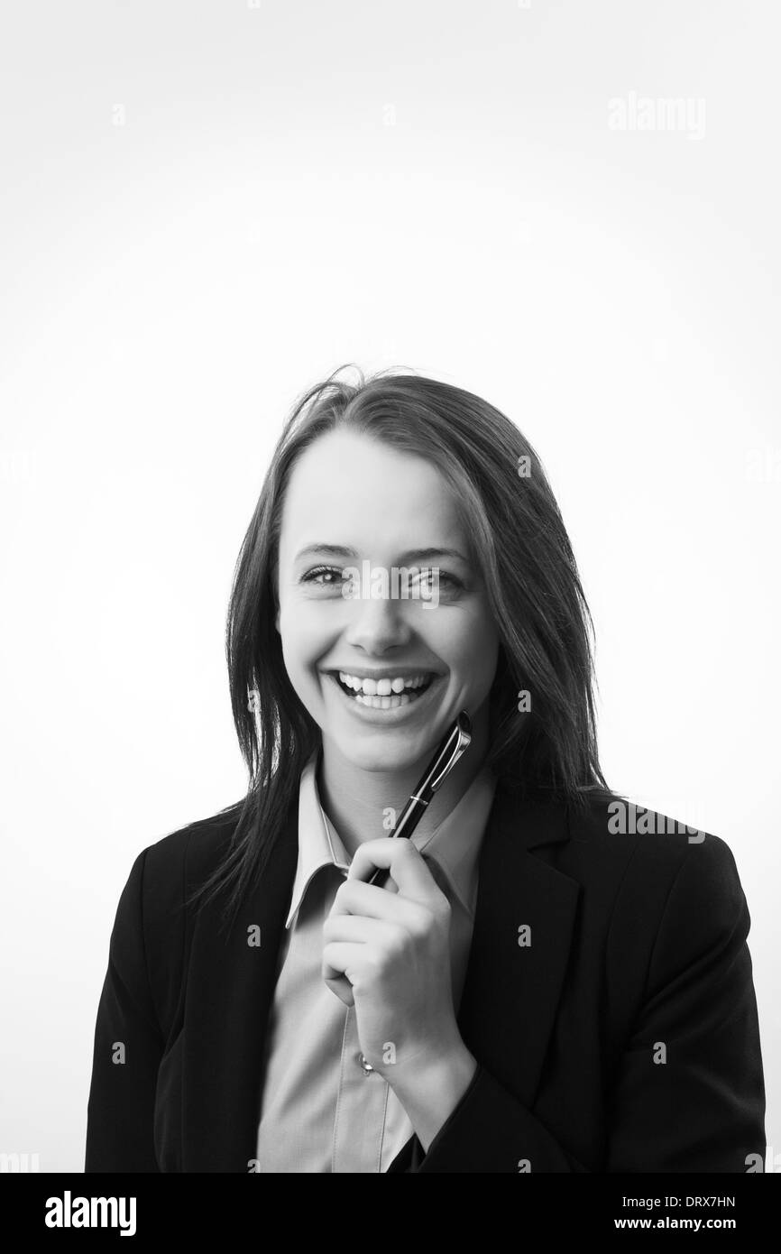 Smiling businesswoman with pen close up portrait Stock Photo