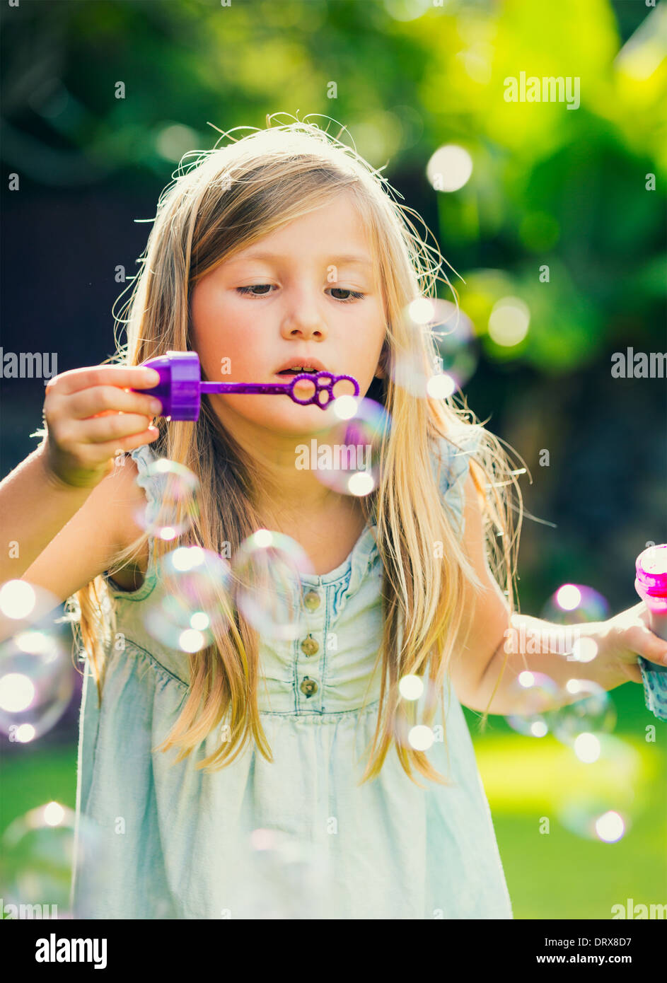 Adorable little girl with soap bubbles Stock Photo - Alamy
