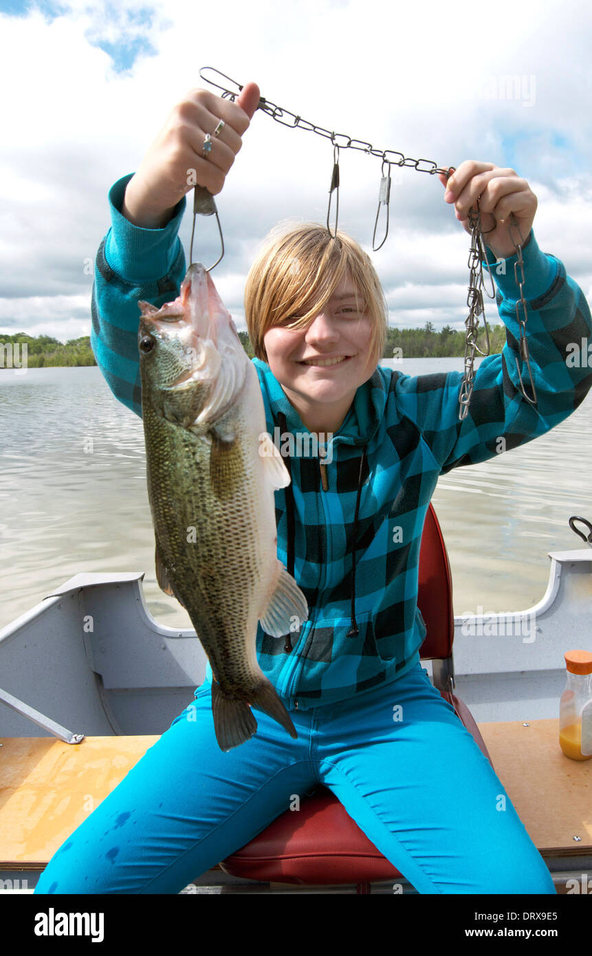 Girl catches a big Bass. Stock Photo