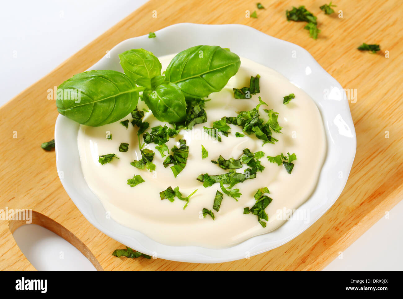 Creamy salad dressing with chopped parsley Stock Photo Alamy