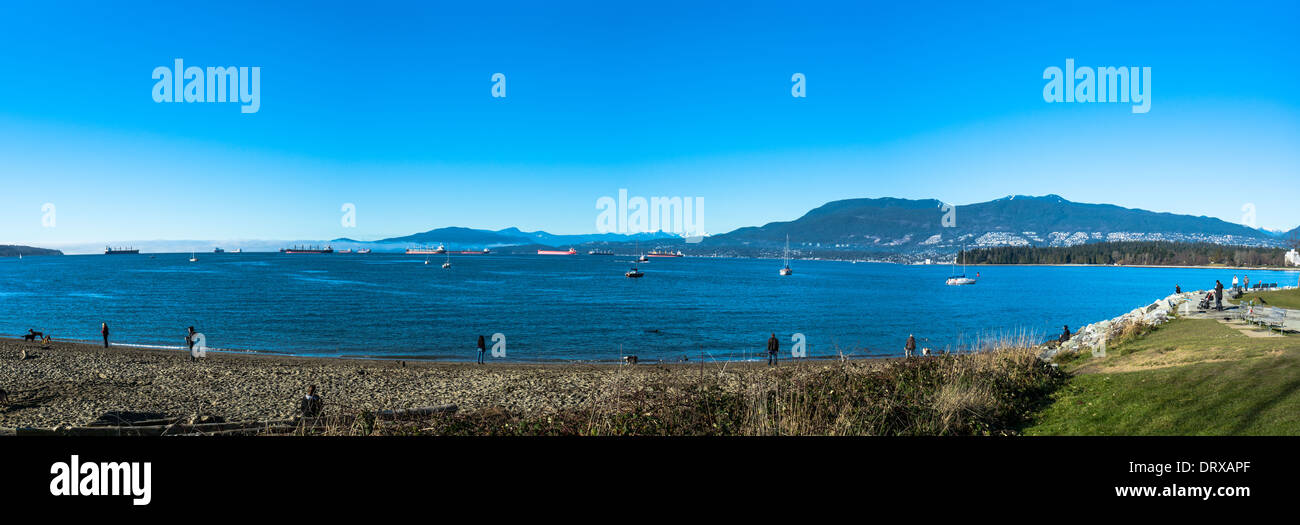 Foreign freighters waiting in Vancouver Harbour.Vancouvers only dog beach. Stock Photo