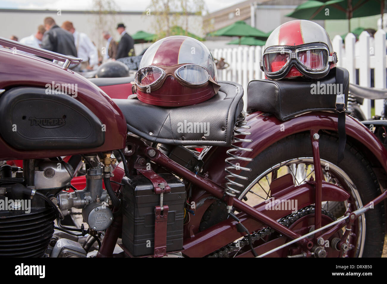 triumph motor bike with vintage helmets Stock Photo - Alamy