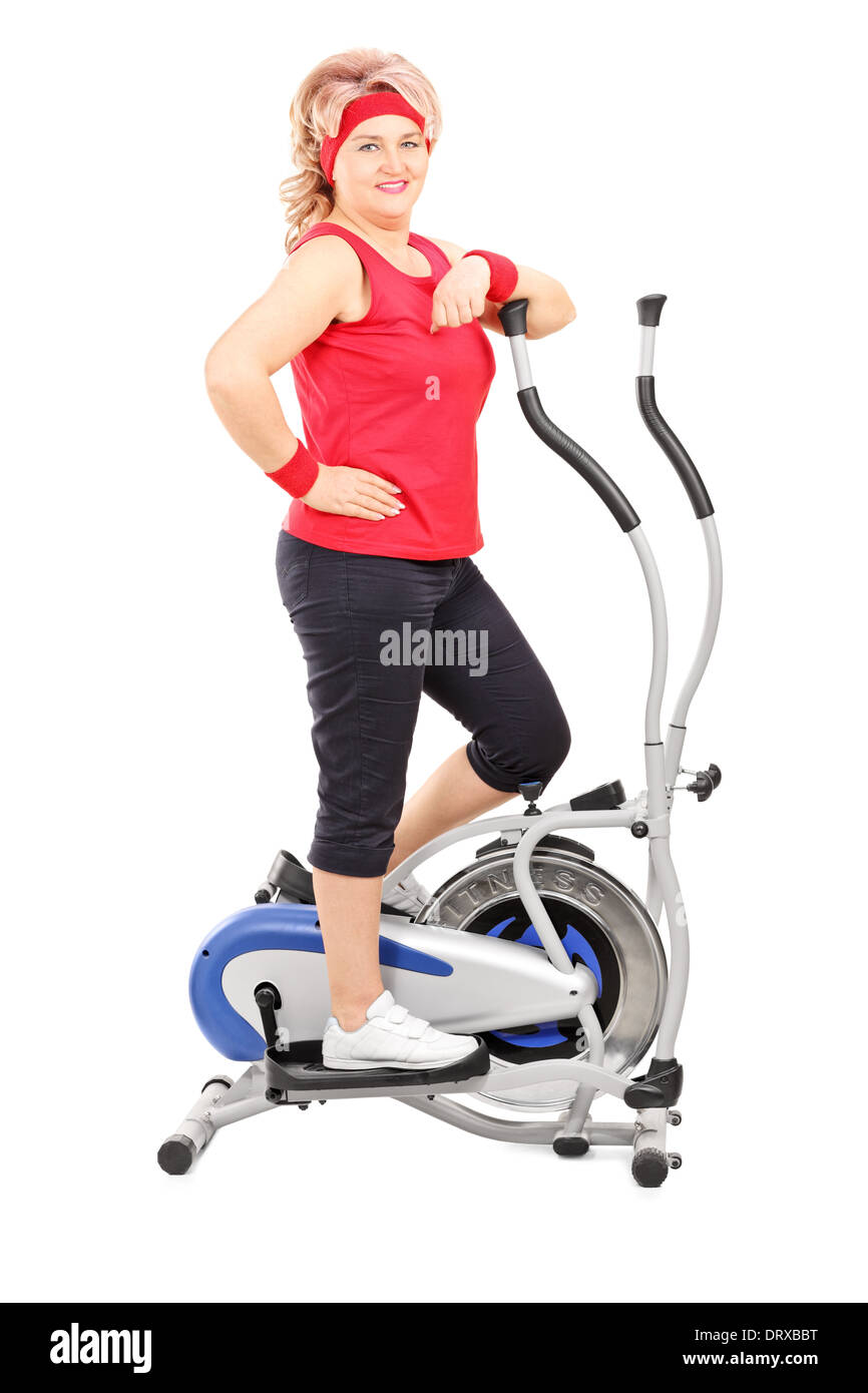 Mature lady posing on a cross trainer machine Stock Photo