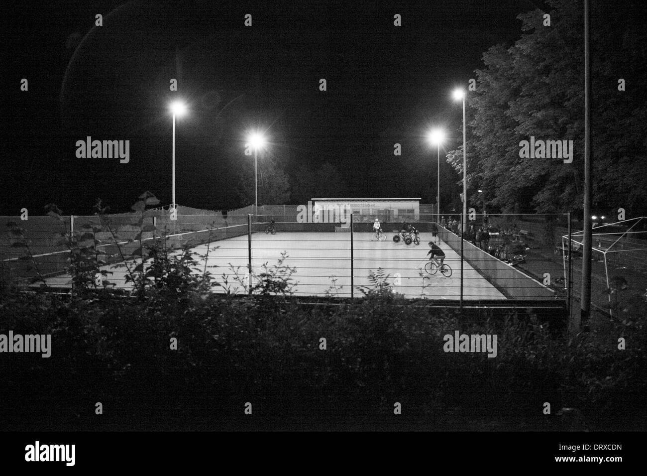 Black and White night photo of an outdoor cement court. Stock Photo
