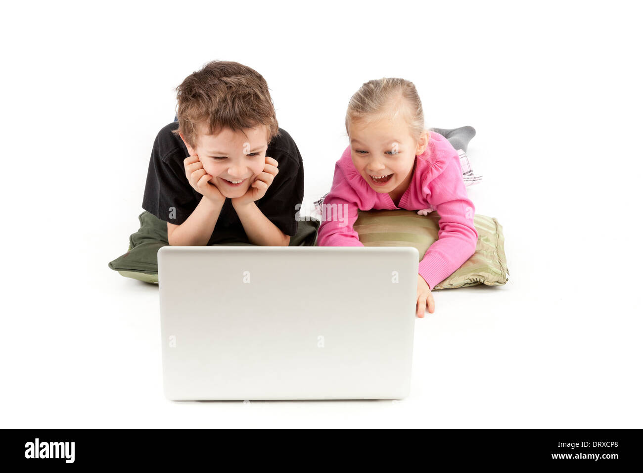 Children are lying and watching the silver Notebook Stock Photo
