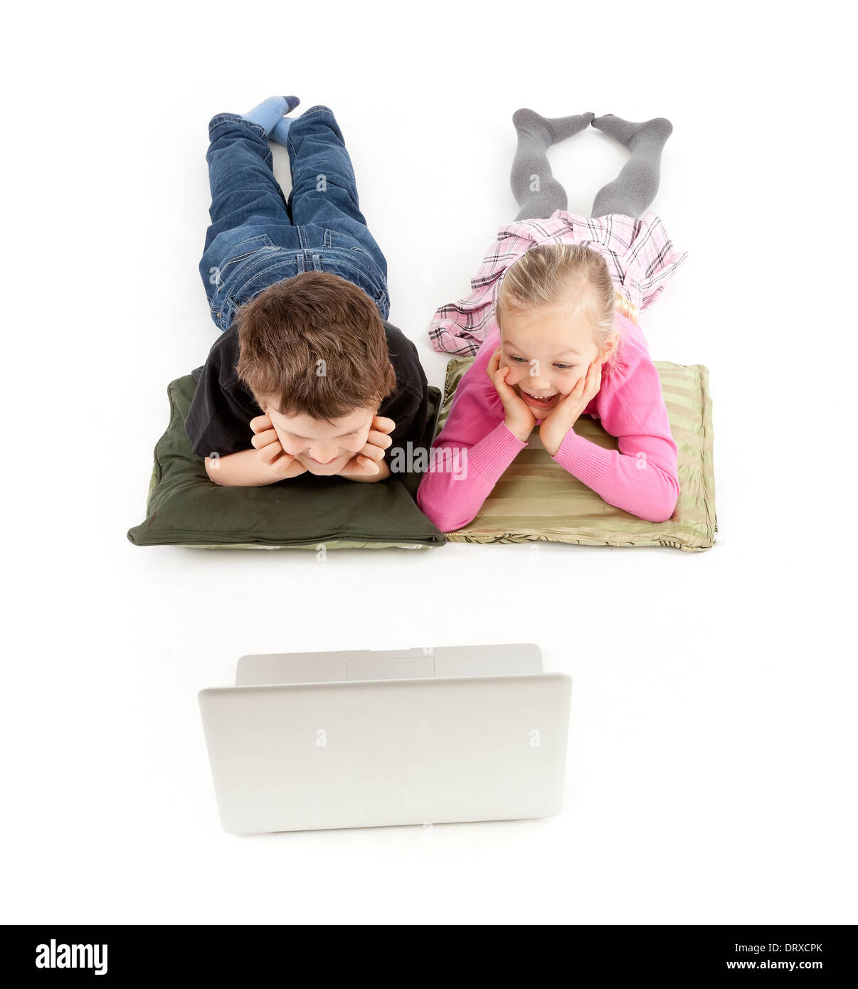 Children are lying and watching the silver Notebook Stock Photo