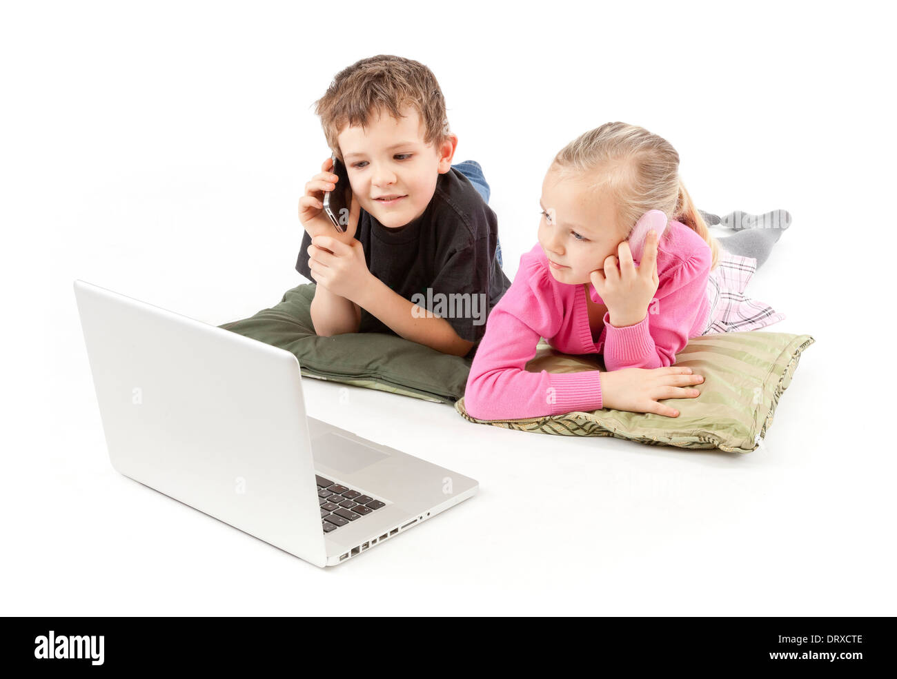 Children are lying, calling and watching the silver Notebook Stock Photo