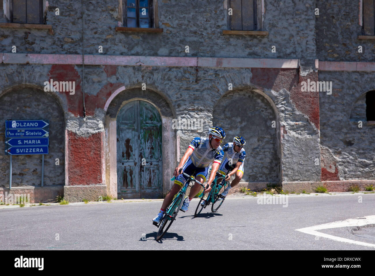 Cyclists ride Bianchi roadbikes on The Stelvio Pass, Passo dello Stelvio, Stilfser Joch, in Northern Italy Stock Photo