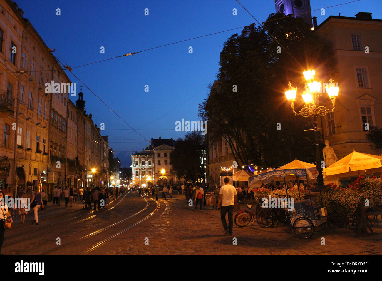 illuminated street of night Lviv city with many lanterns Stock Photo