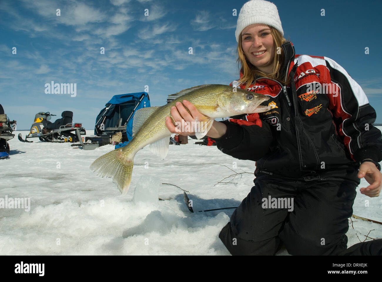 Woman ice fishing holding lake hi-res stock photography and images