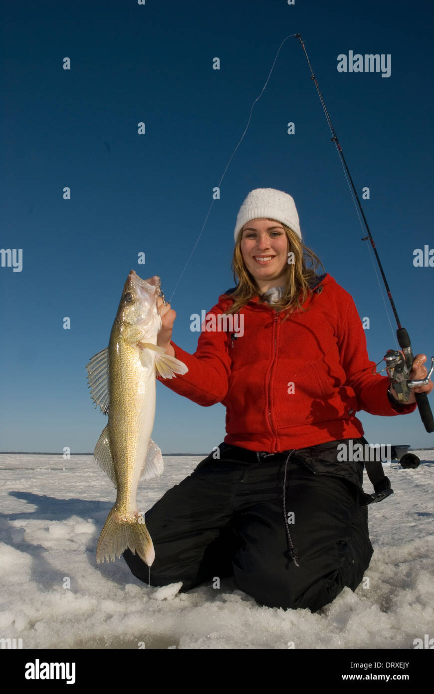 A young girl holds up a winter walleye she caught ice fishing Stock Photo Alamy