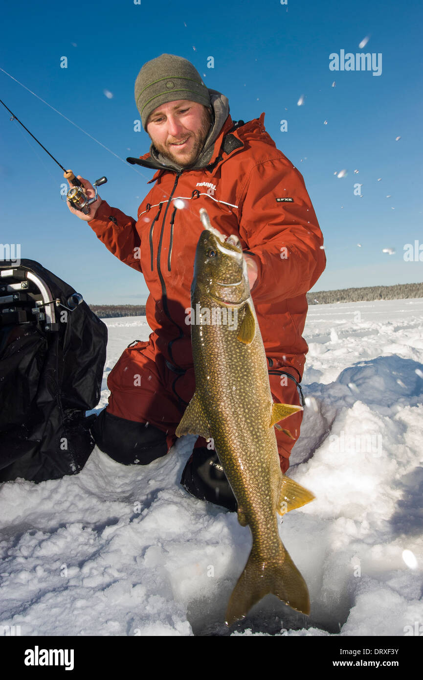 Man holding trout ice fishing hi-res stock photography and images