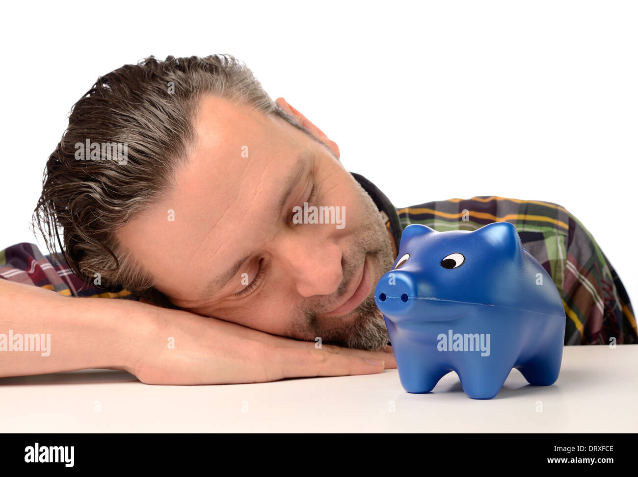 Sleeping man with a blue piggy bank, financial concept Stock Photo - Alamy