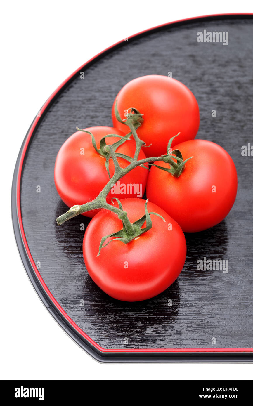 bunch of red tomatoes on plate Stock Photo