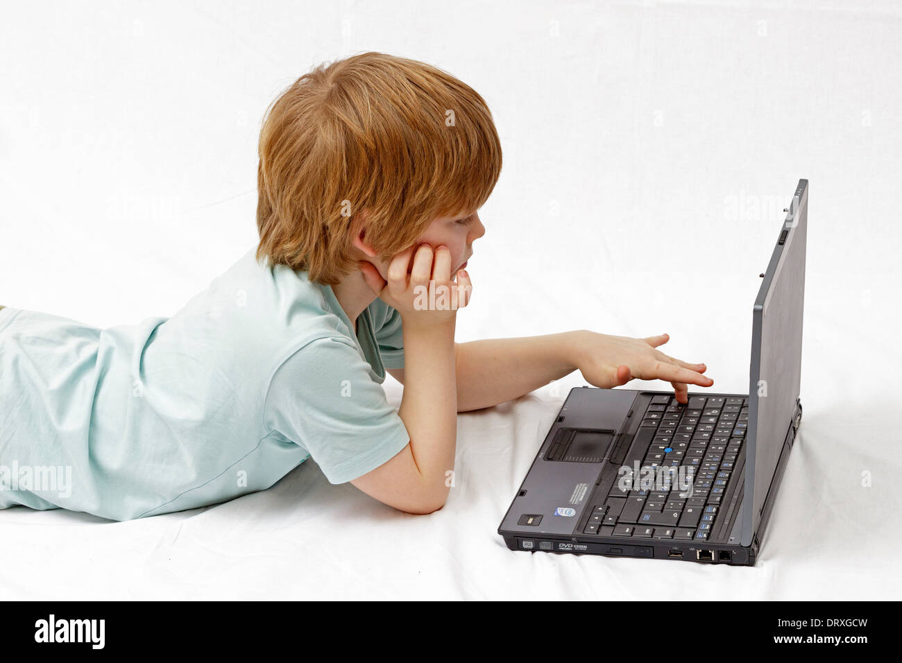 portrait of a young boy in front of a laptop Stock Photo