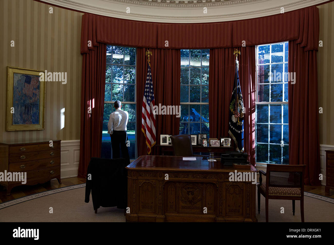 US President Barack Obama looks out the window of the Oval Office of the White House September 17, 2013 in Washington, DC. Stock Photo