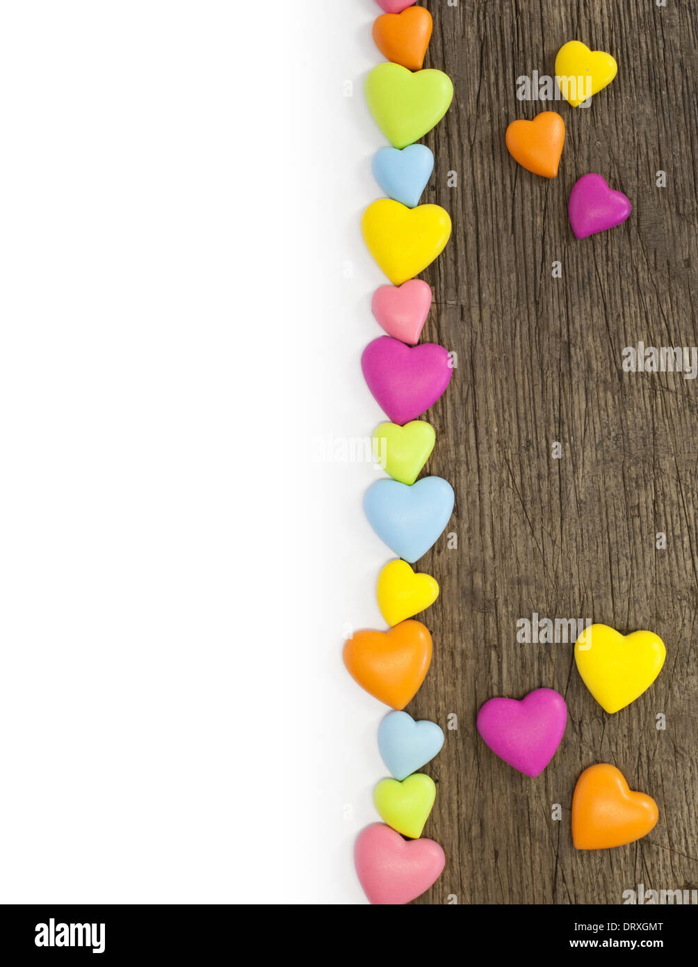 Colorful hearts on wooden background. All isolated on white. Stock Photo