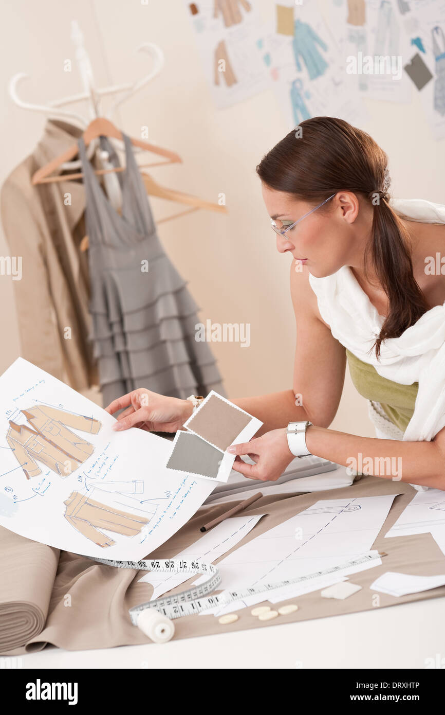 Female fashion designer working with sketches Stock Photo - Alamy