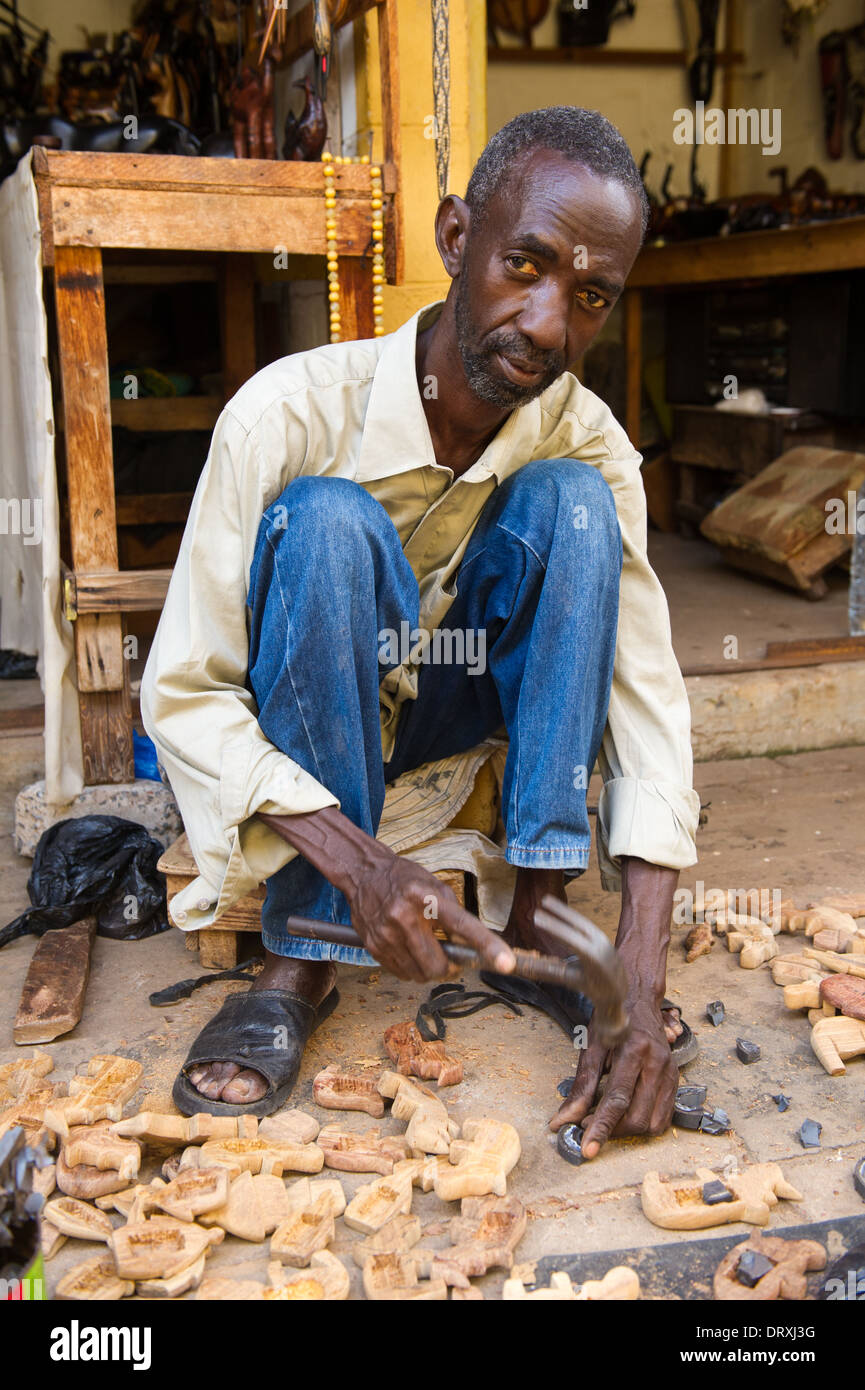 Wood carver at work, Royal Albert Market, Banjul, the Gambia Stock Photo