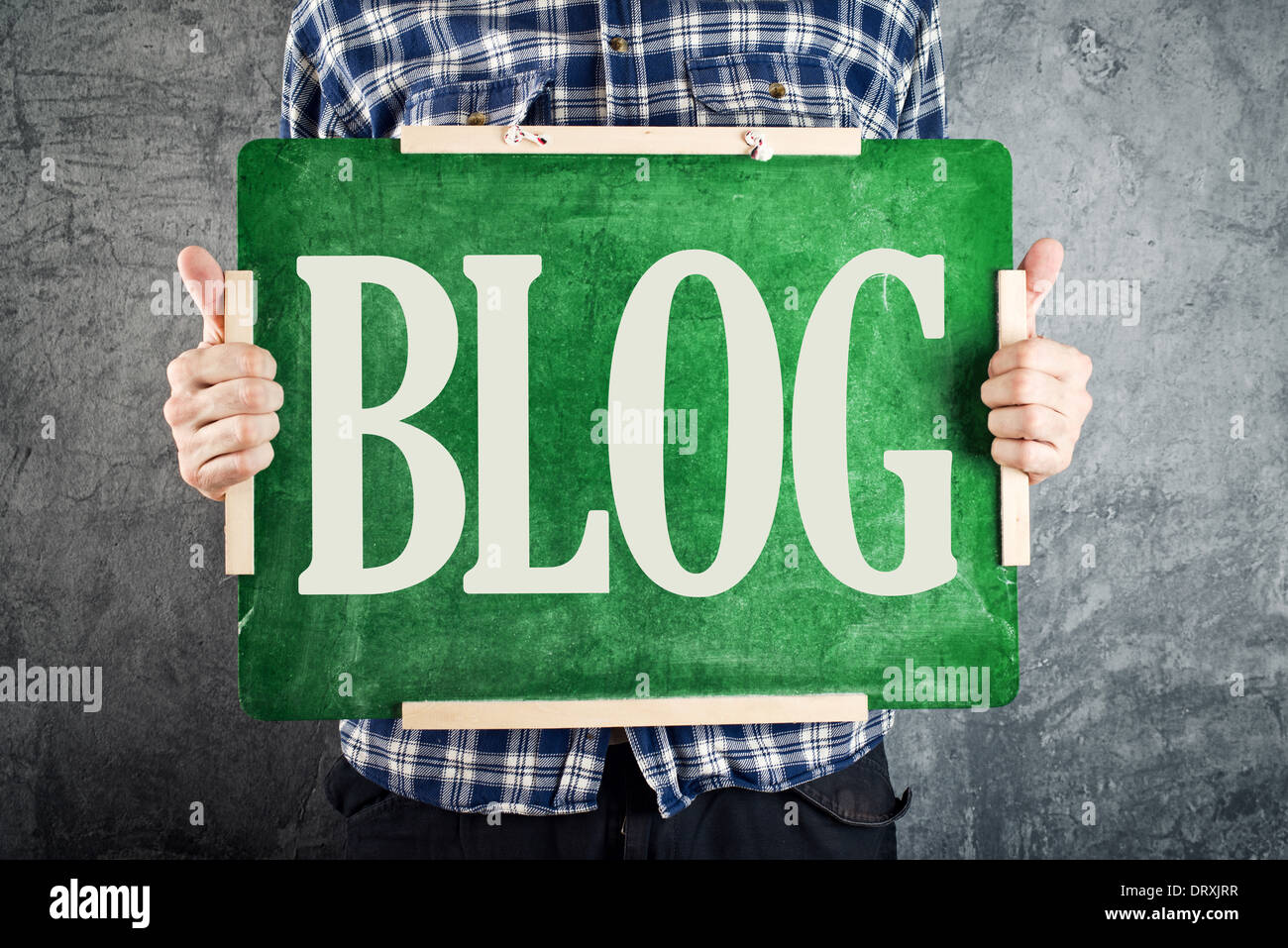 Teacher holding green chalkboard with title BLOG. Blogging concept. Stock Photo