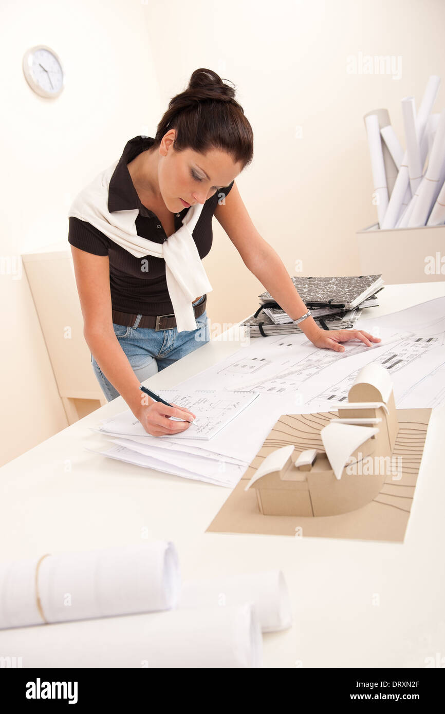 Female architect at the office writing notes Stock Photo