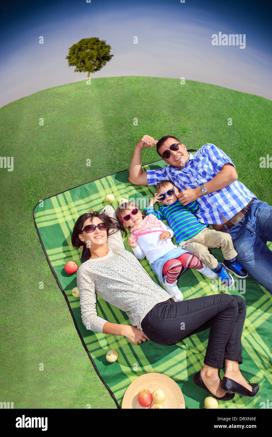 young family making picnic on the meadow Stock Photo