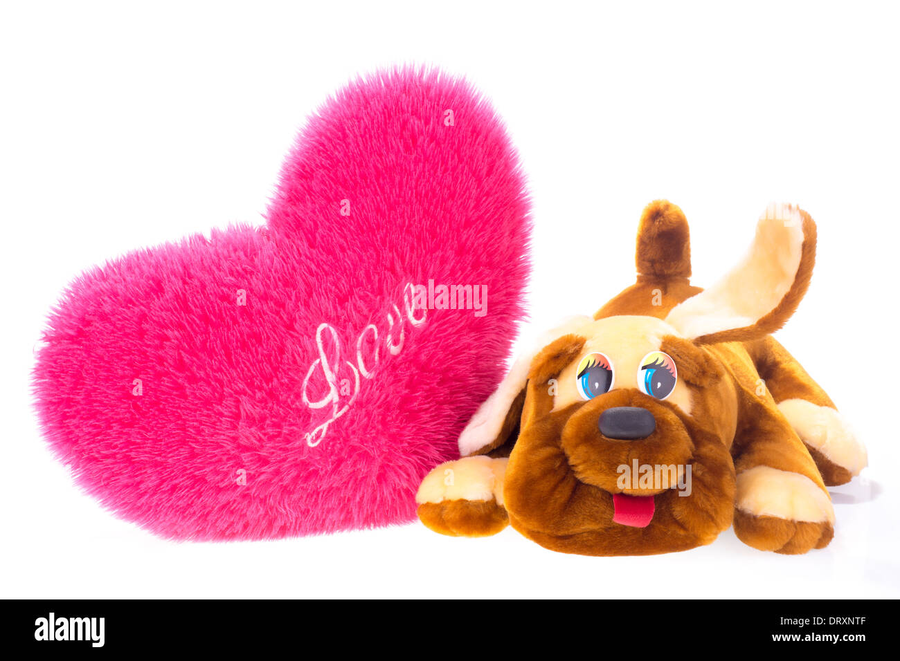 Toy dog and heart-shaped pillow isolated on white Stock Photo