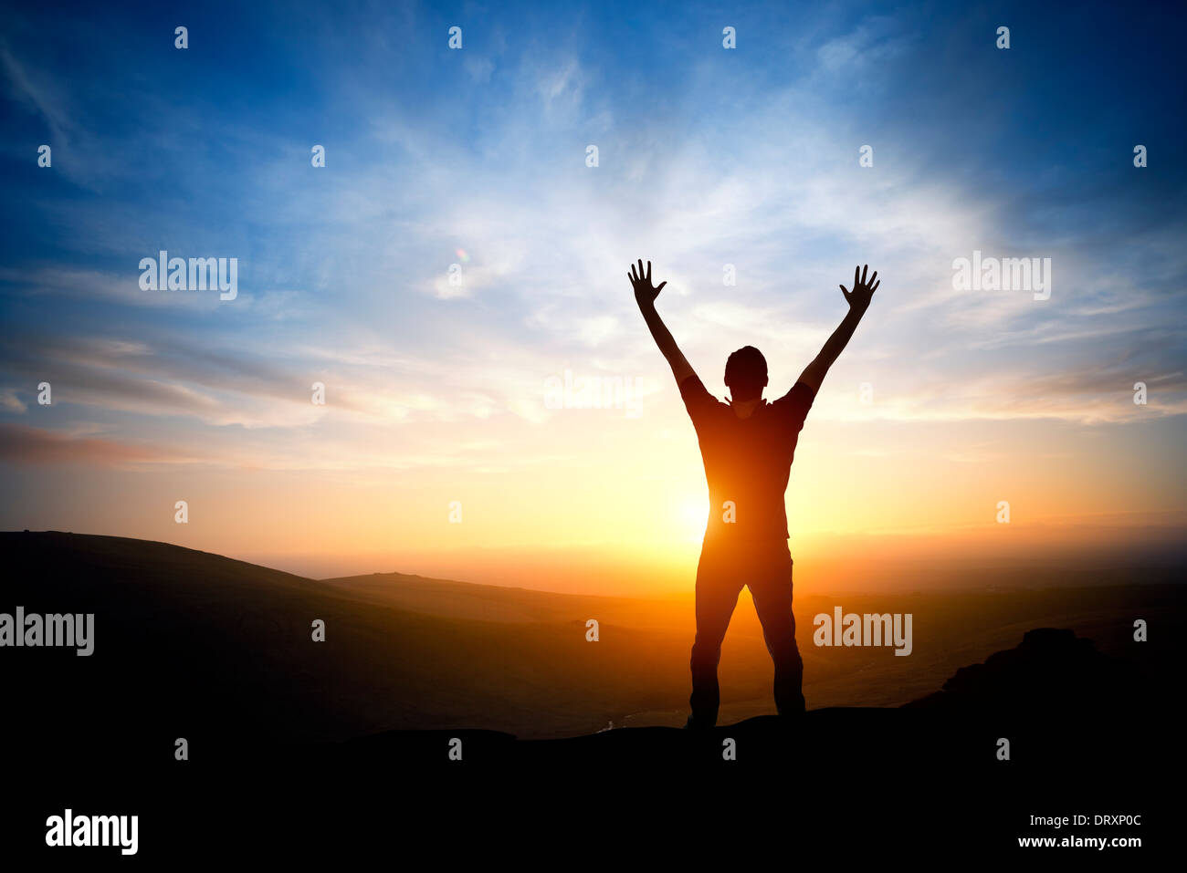 Fresh New Morning - A person reaching up on a bright morning sunrise. Stock Photo