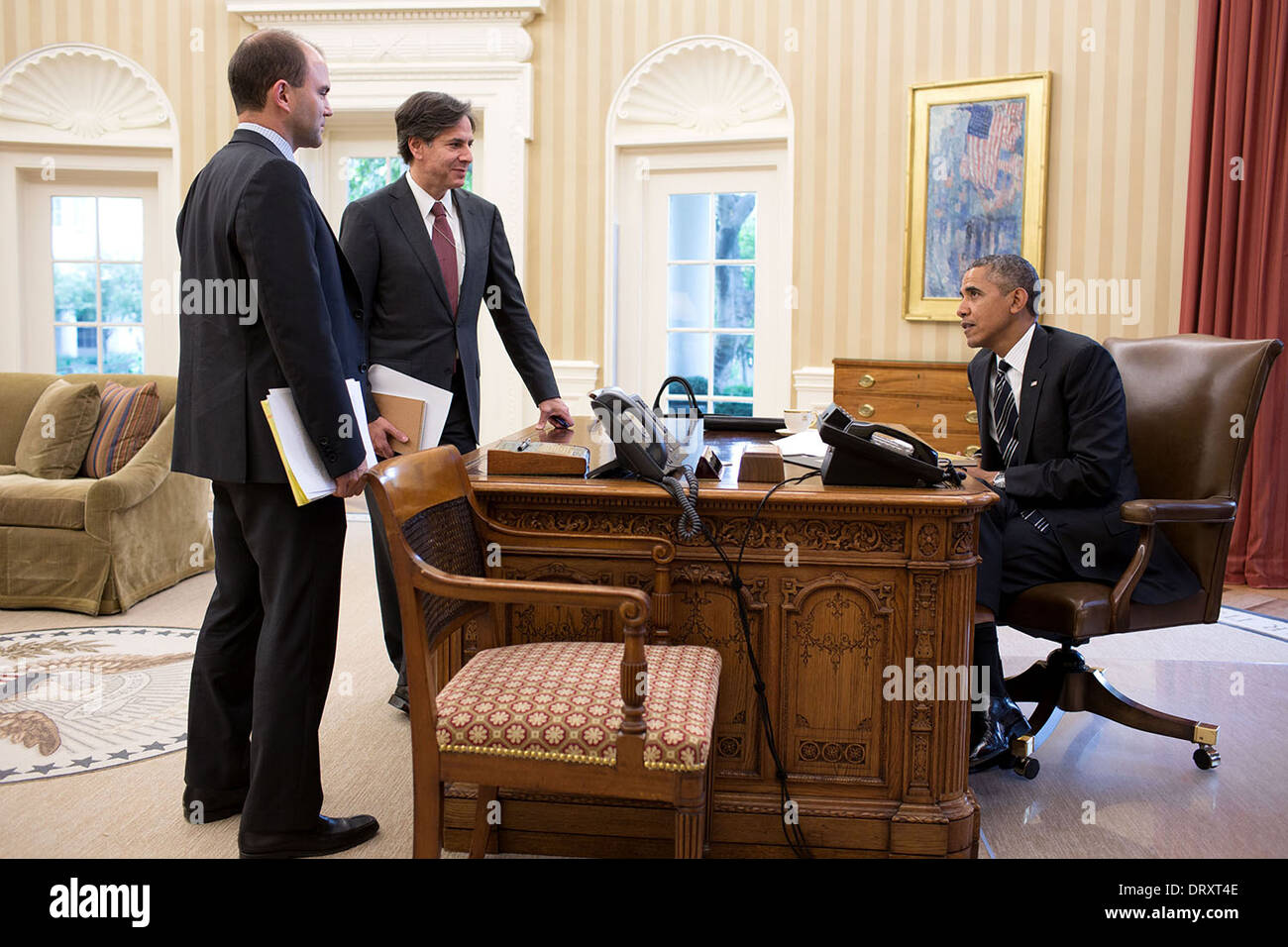 US President Barack Obama talks with Ben Rhodes, Deputy National Security Advisor for Strategic Communications, left, and Deputy National Security Advisor Tony Blinken prior to a phone call with President Hassan Rouhani of Iran, in the Oval Officeof the White House September 27, 2013 in Washington, DC. Stock Photo
