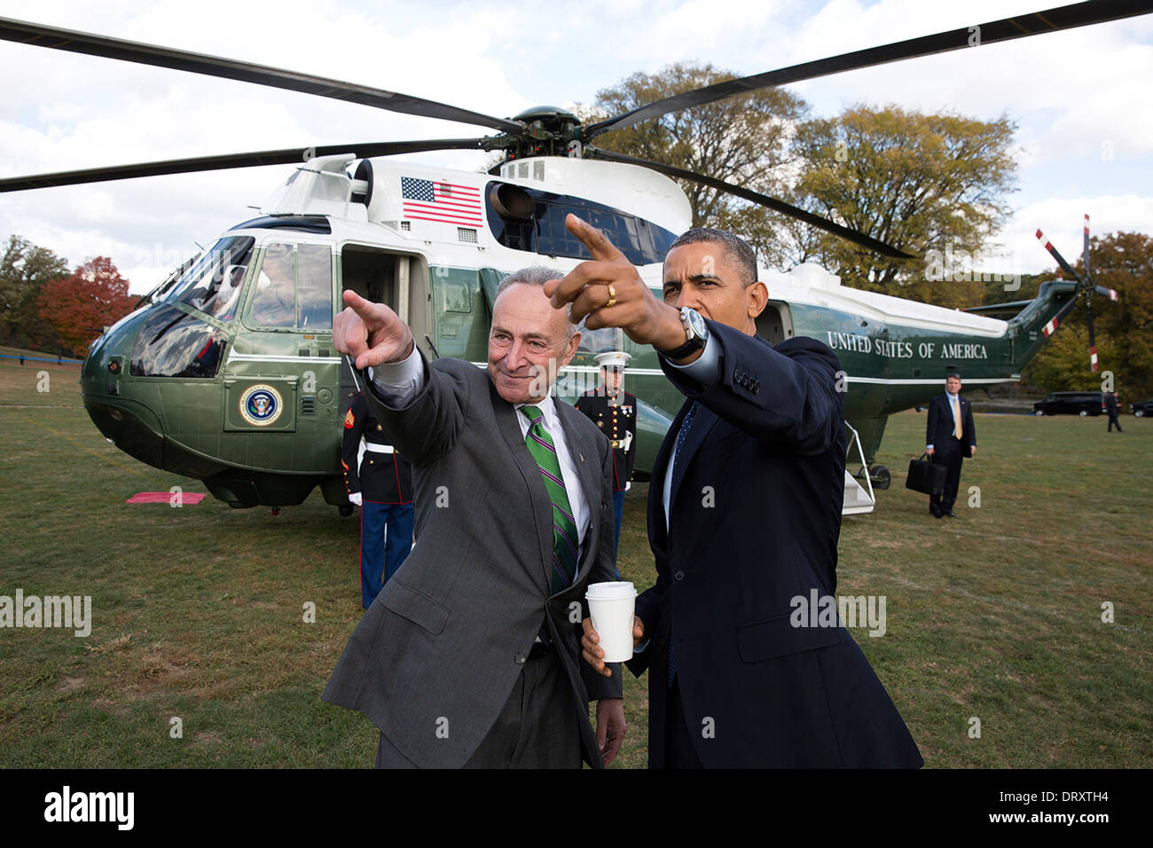 US President Barack Obama is met by Senator Chuck Schumer upon arrival aboard Marine One at the Prospect Park landing zone October 25, 2013 in New York, NY. Stock Photo