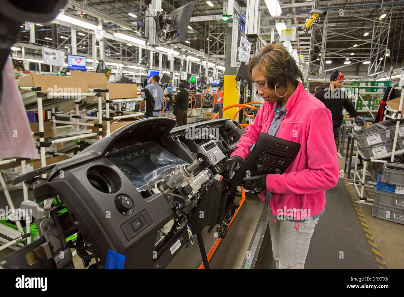 Workers make dashboards for Ford at Detroit Manufacturing Systems Stock
