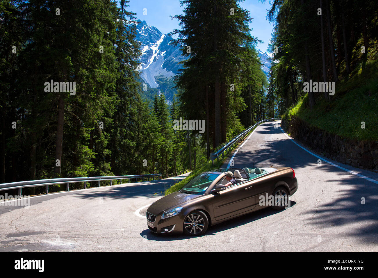 Volvo cabriolet sports car on The Stelvio Pass, Passo dello Stelvio, Stilfser Joch, route to Trafio in The Alps, Italy Stock Photo